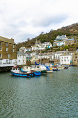 Fototapeta na wymiar Fishing and Leisure boats moored in the historic harbour at Polperro, Cornwall.