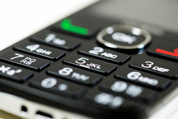 Obraz premium Mobile phone keypad close up macro shot, shallow depth of field, image for background.