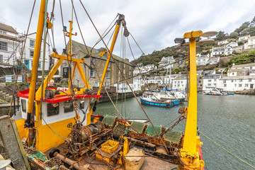 Yellow and Red Fishing Boat Moored in the Historic Polperro Harbour, Cornwall.