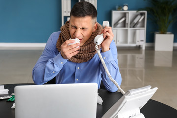 Young man ill with flu in office