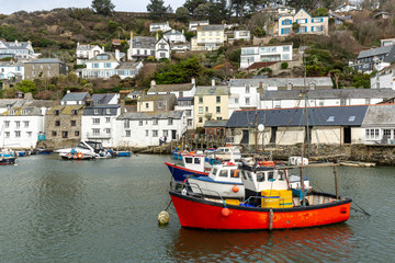Red Fishing boat moored in the historic and quaint Polperro Harbour in Cornwall, UK