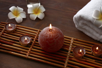 Beautiful spa composition with burning candles on wooden table