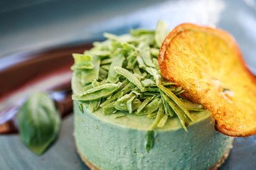 Delicious mint cheesecake with candied fruit and jam on plate