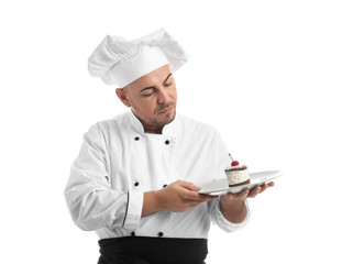 Male chef with tasty dessert on white background