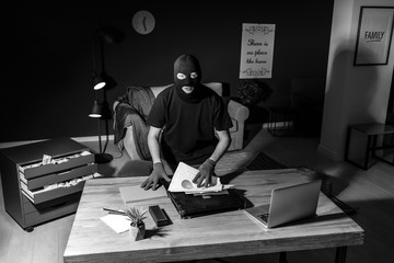 Male thief indoors, view through security camera
