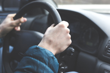 Man hands on the steering wheel
