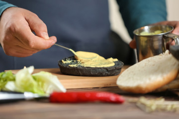 Male chef preparing burger in kitchen