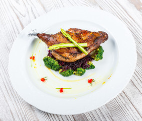 Grilled pork chop steak on the bone with asparagus and broccoli on light wooden background close up. Hot Meat Dishes. Top view