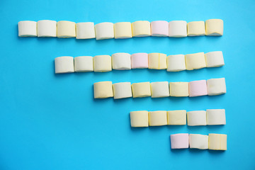 Tasty sweet marshmallows on color background, top view