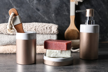 Soap and bathing accessories on table