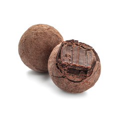 Tasty chocolate truffles on white background