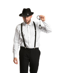 Detective with handcuffs on white background