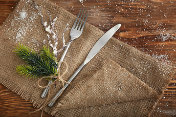 Cutlery for Christmas table setting on wooden background