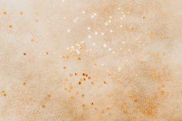 Beige stone background with golden stars on in.