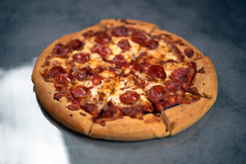 Fresh pepperoni pizza on grey