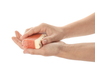 Female hands with soap bar on white background