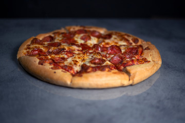 Fresh pepperoni pizza on grey