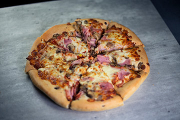 Sliced pizza on grey