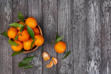 Tangerines on dark wooden background