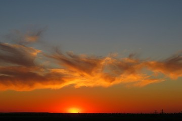 Beautiful orange fiery sunset over the city with orange clouds, natural background