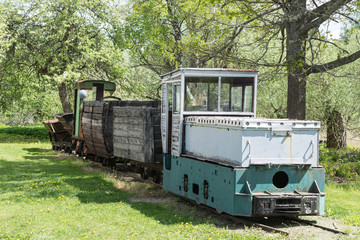 Old train and locomotive. Railroad tracks stretches and green grass and trees. Railway road environment background.