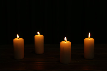 Burning candles on dark background