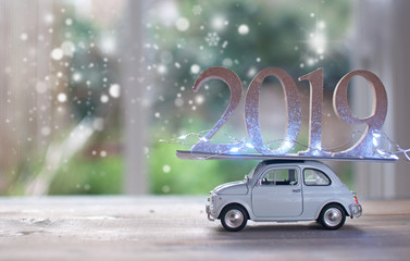 2019 on top of a toy car with snow outside