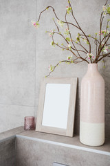 Home decor, neutral vases with empty frame against grey wall modern decoration