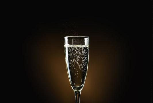 Glass of champagne on dark background