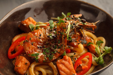 Stir fry with udon noodles, shrimps (prawns) and vegetables. Asian healthy food, meal