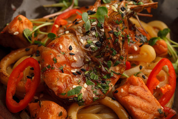 Stir fry with udon noodles, shrimps (prawns) and vegetables. Asian healthy food, meal