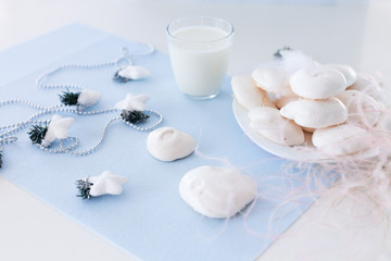 Homemade meringue cookies and glass of milk