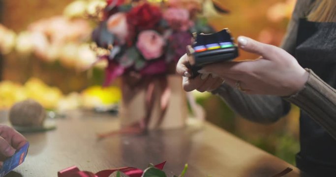 Close up of man buying flower composition