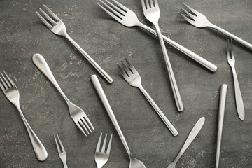 Set of forks on grey background