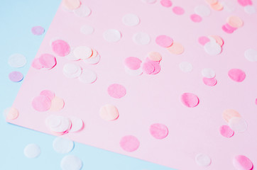 Background with round confetti on a pink-blue background.