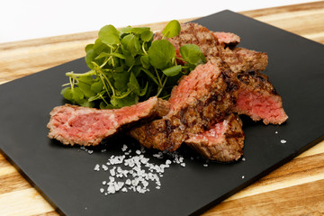 Succulent and juicy rare beef steak, with watercress garnish