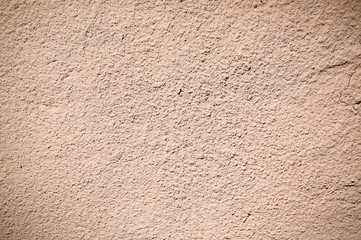 Beige wall texture background. Ribbed surface with holes and scratches.