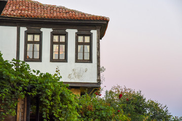 single Old house red tiled roof at sunset background