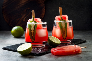 Spicy watermelon popsicle margarita cocktail with jalapeno and lime. Mexican alcoholic drink for Cinco de mayo party