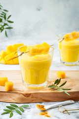 Mango Lassi, yogurt or smoothie with turmeric. Healthy probiotic Indian cold summer drink