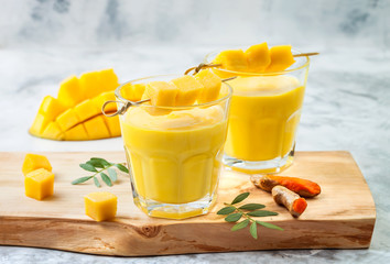 Mango Lassi, yogurt or smoothie with turmeric. Healthy probiotic Indian cold summer drink