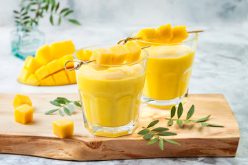 Mango Lassi, yogurt or smoothie with turmeric. Healthy probiotic Indian cold summer drink