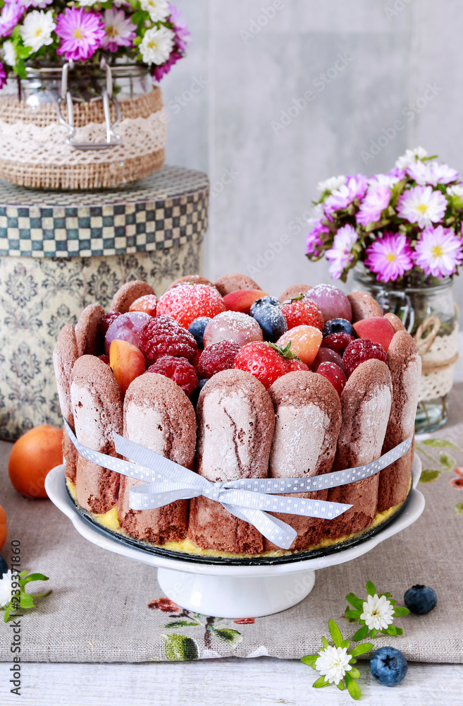 Sticker french charlotte cake with summer fruits.