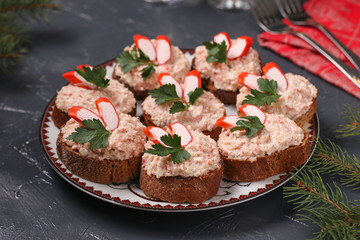 Canapes with cream cheese, crab sticks and beans on the dark background