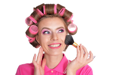 Portrait of young woman in hair curlers posing