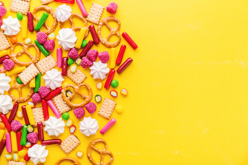 Sweets flat lay on yellow background