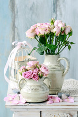 Bouquet of pink roses on blue wooden background