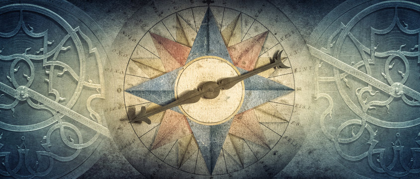 Old compass and Astrolabe - ancient astronomical device on vintage background. Abstract old conceptual background on history, mysticism, astrology, science, etc. Retro style.