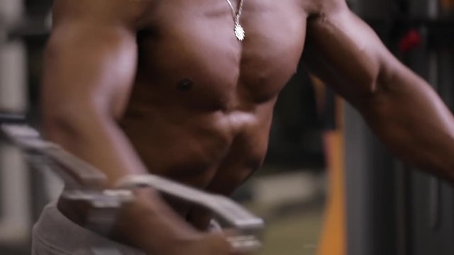 African american man making exercice on training apparatus in gym