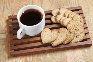 Coffee and tasty cookies in the shape of a heart